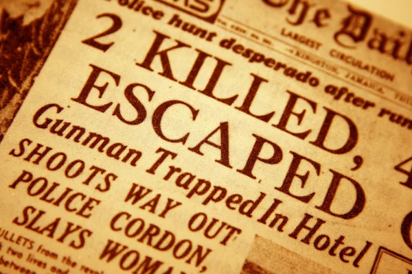 stock image Daily newspaper headline that reads killed and escaped