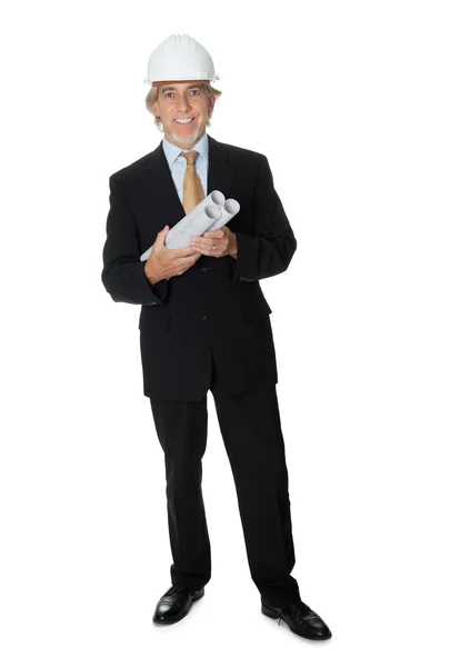 Businessman wearing hardhat holding blueprints — Stock Photo, Image