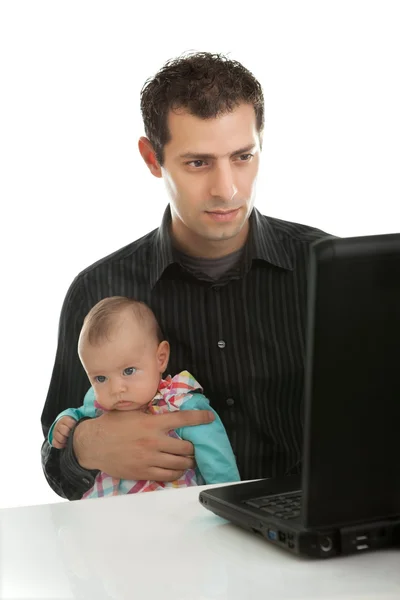 Молодой отец с дочерью работают над ноутбуком — стоковое фото
