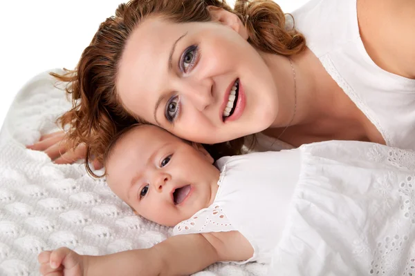 Beautiful young mother lying on bed — Stock Photo, Image