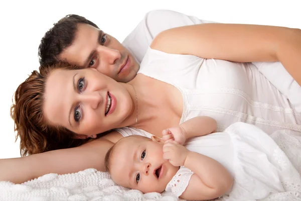 Sweet young family lying together on bed — Stock Photo, Image
