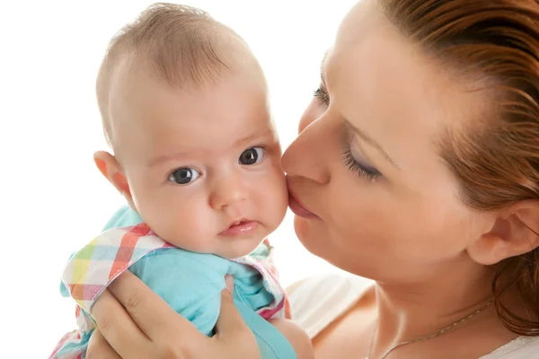 Loving mother kissing her daughter on cheek Stock Photo