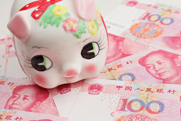 stock image Piggy bank on china banknote