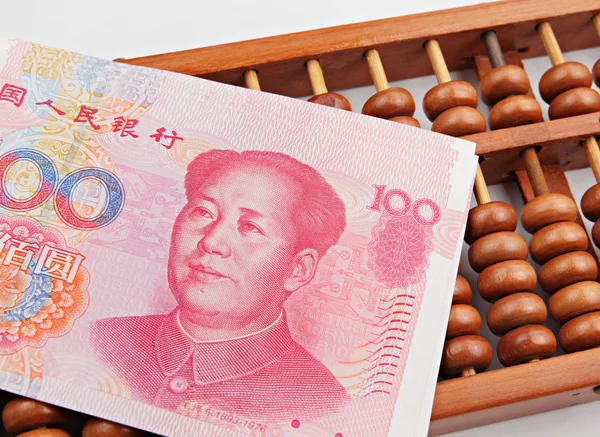 Abacus and china dollar banknote — Stock Photo, Image