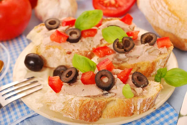 Crostini with pate and olives — Stockfoto