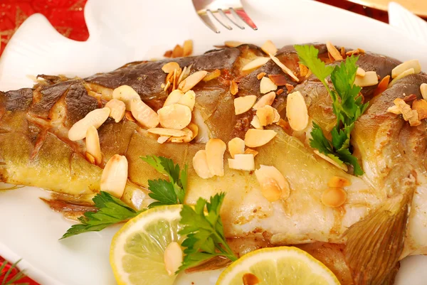 Carp baked with almonds on christmas table — Stock Photo, Image