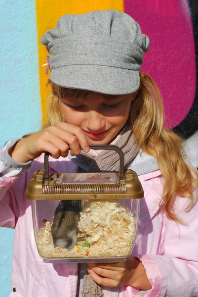 Young girl with hamster in portable transporter — Stock Photo, Image