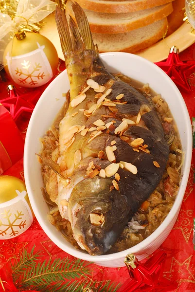 Carp baked with almonds on sauerkraut for christmas — Stock Photo, Image