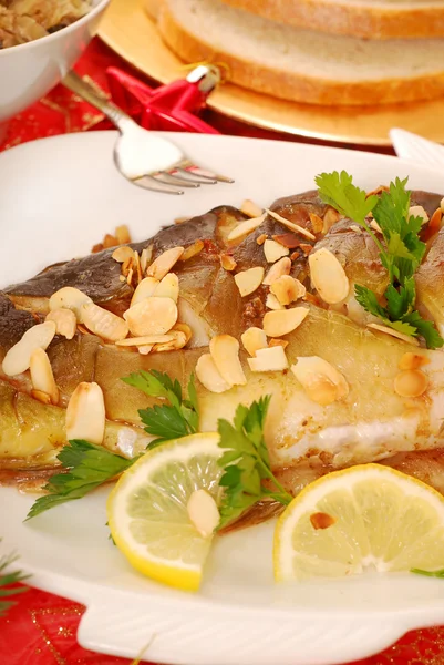 Carp baked with almonds on christmas table — Stock Photo, Image