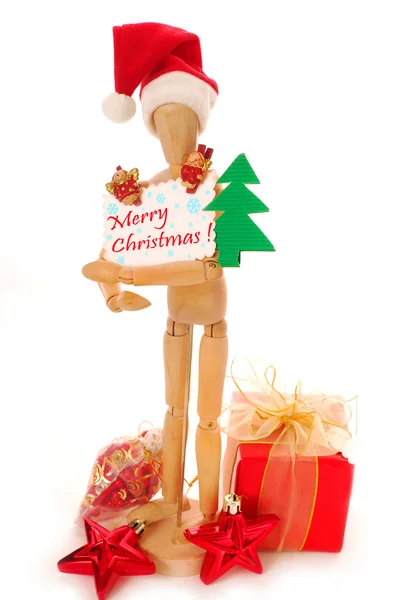 Wooden mannequin holding christmas card — Stock Photo, Image