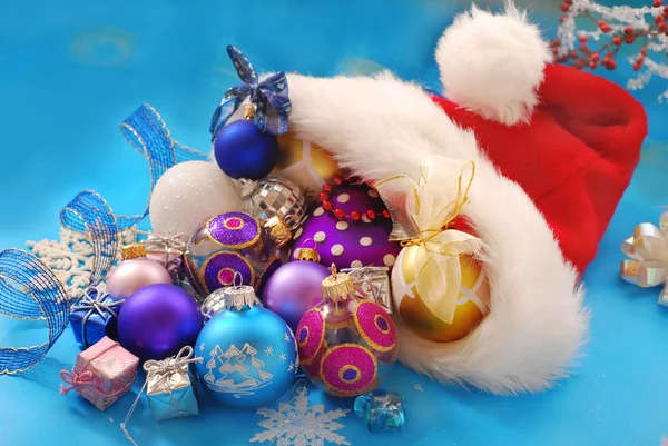 Christmas baubles in santa hat — Stock Photo, Image