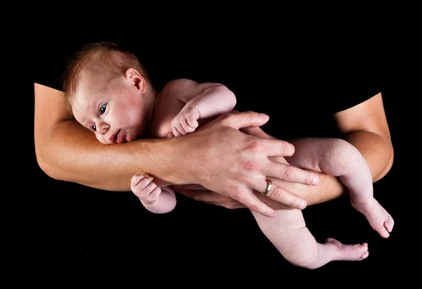 INfant girl in fathers arms isolated on black Stock Picture