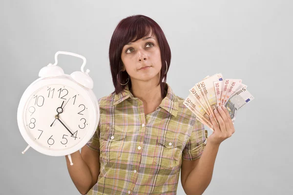 Mulher segurando relógio e dinheiro — Fotografia de Stock
