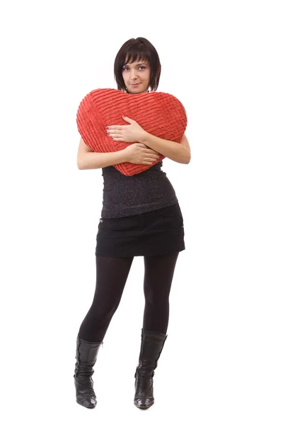 Žena objetí polštář tvaru srdce — Stock fotografie