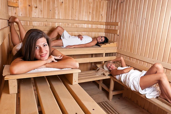 Three women relaxing a hot sauna — Stock Photo, Image
