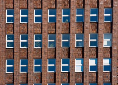 Facade of an old red brick building clipart