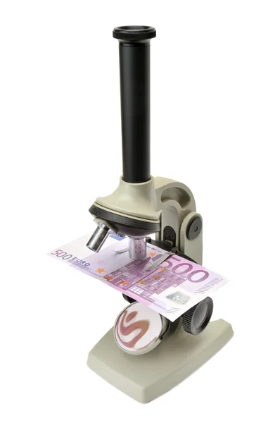 Mikroskop und Geld — Stockfoto