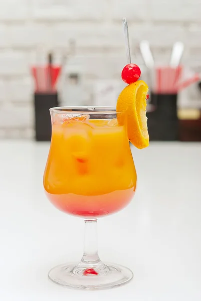 Alcoholic cocktail with a cherry on the table — Stock Photo, Image