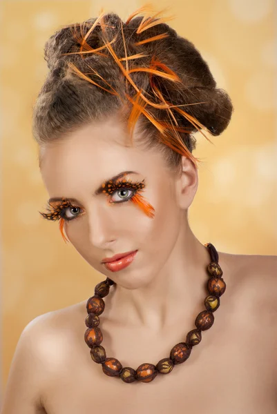 Girl with a creative hairstyle and makeup — Stock Photo, Image