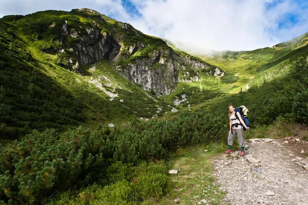 Backpacker-Mädchen erkundet die Berge. — Stockfoto