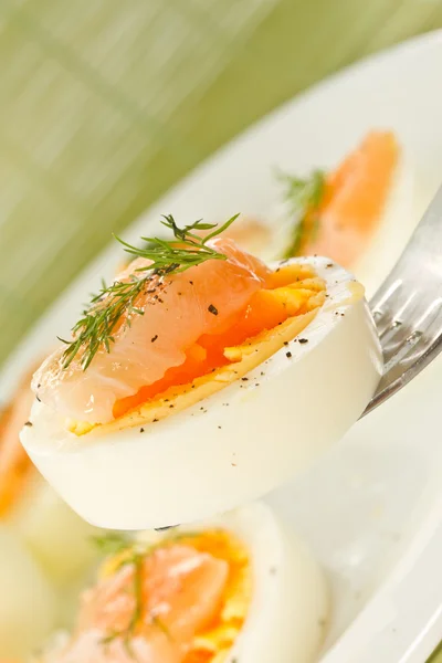 Boiled eggs with salted salmon — Stock Photo, Image