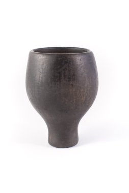 Clay pot of black color on a white background