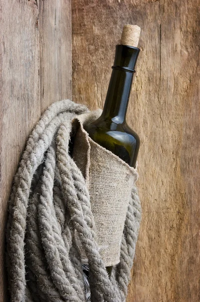 Bottle wrapped with rope — Stock Photo, Image