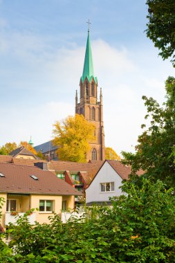 Brick church towering over houses