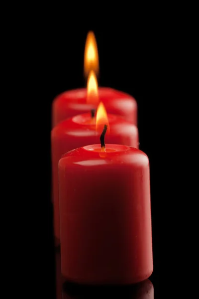 Três velas vermelhas — Fotografia de Stock