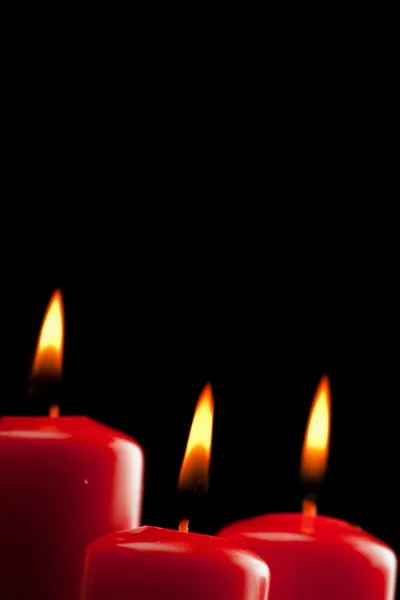 Four red candles over black — Stock Photo, Image