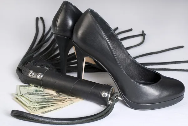 stock image Strict Black Leather Flogging Whip, high heels shoes and money.