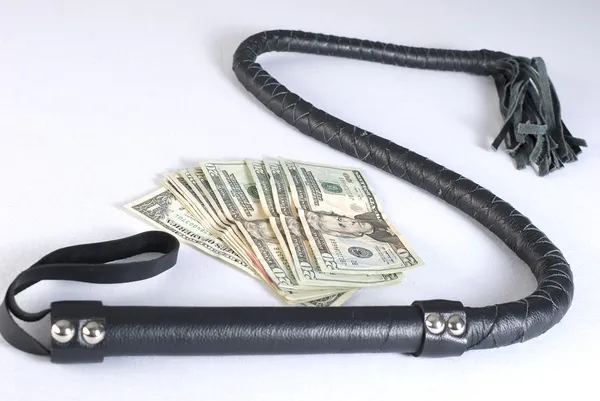 Black Leather Bullwhip and money. — Stock Photo, Image