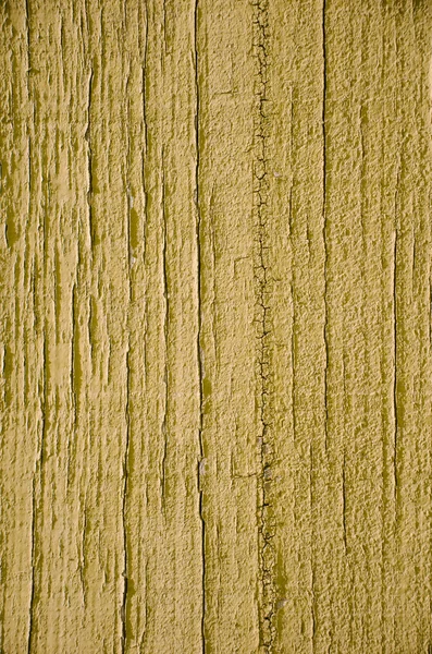 Желтая краска на деревянном фоне — стоковое фото