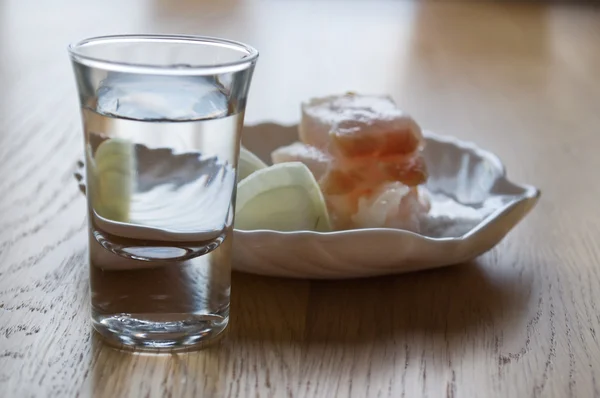 stock image Glass with vodka and a small dish of lard and onions