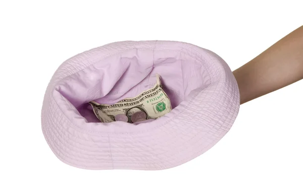 Dollars placed on cap which is held by man — Stock Photo, Image
