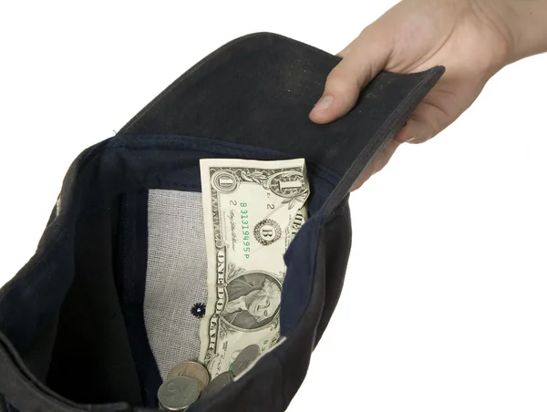 Dollars placed on cap which is held by man — Stock Photo, Image