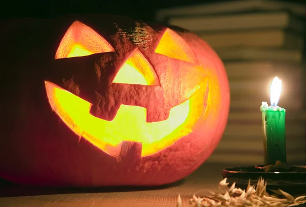 Creepy pumpkin near candle, halloween concept — Stock Photo, Image