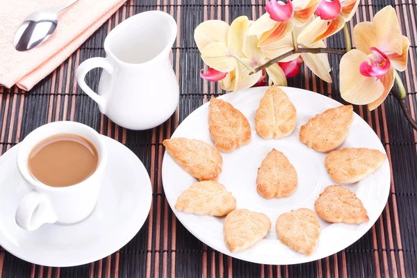 Sugar cookies and a cup of coffee with cream — Stock Photo, Image