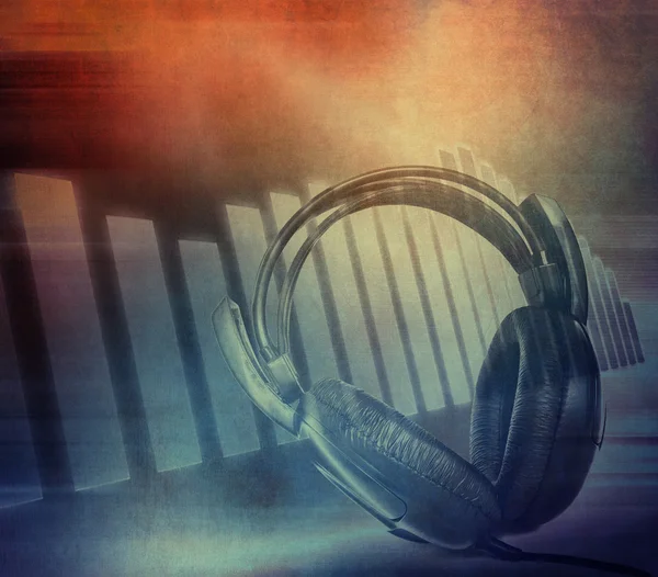 Grunge musical background, equalizer and headphones on dirty color background — Stock Photo, Image