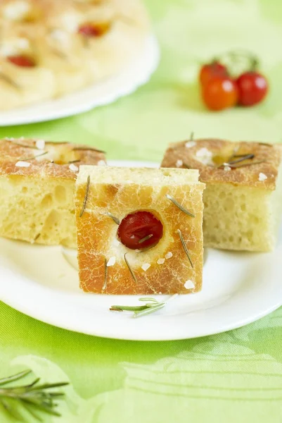 Focaccia bread with cherry tomatoes, rosemary and salt — Stock Photo, Image