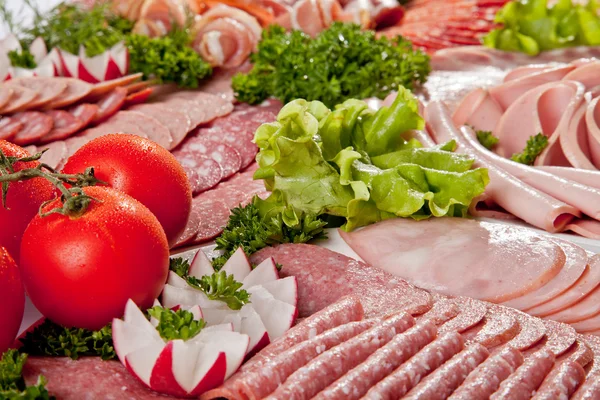 Cutting sausage and cured meat with a parsley — Stock Photo, Image