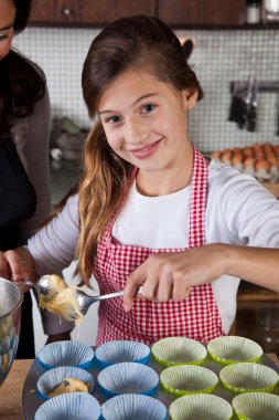 Mother and daughter baking at home clipart