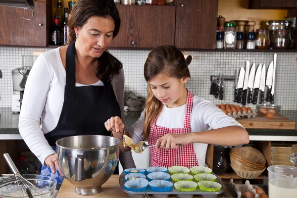 Mother and daughter baking at home