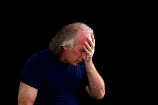 Stock image Upset man holding head