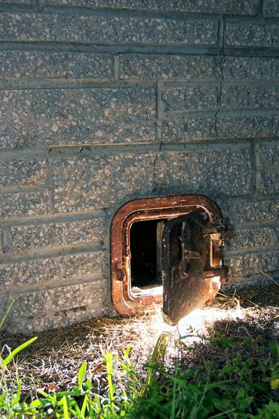 stock image Old rusted iron door ajar at night