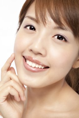 Happy beautiful asian woman's face with fresh clean skin clipart