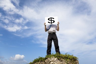 Businessman standing on a peak and holding money mark clipart