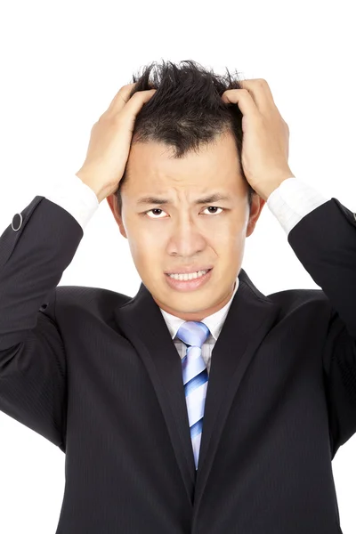 Tensionado joven asiático hombre de negocios con dolor de cabeza en blanco —  Fotos de Stock