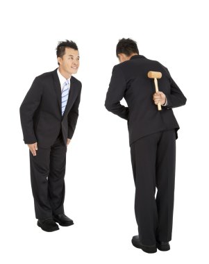 Two asian businessman bowing and holding hammer behind clipart