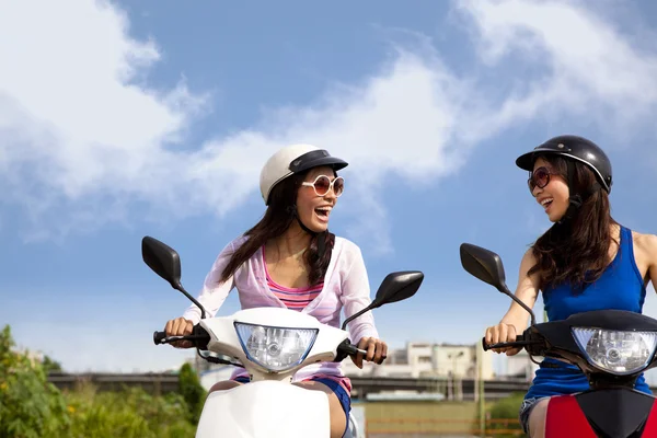 Happy girls having road trip on a scooter — Stock Photo, Image